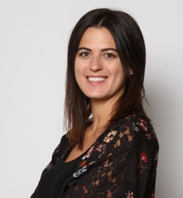 woman smiling at camera wearing black shirt headshot