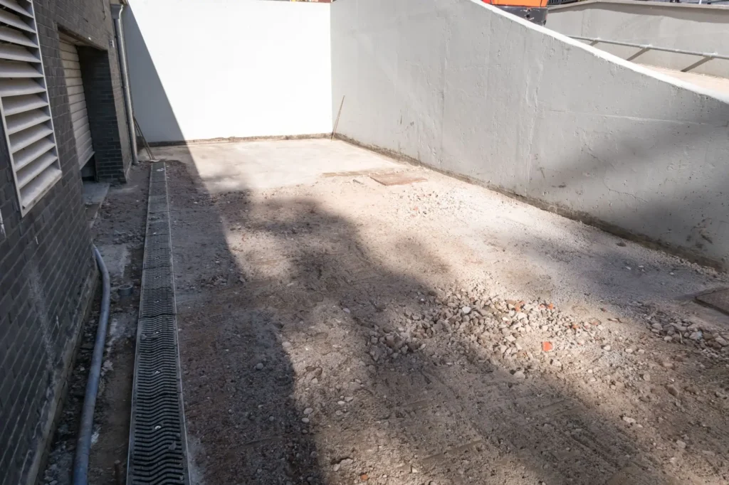 Current image: Bare soil on a newly constructed property in Edmonton before hydroseeding and erosion control treatment