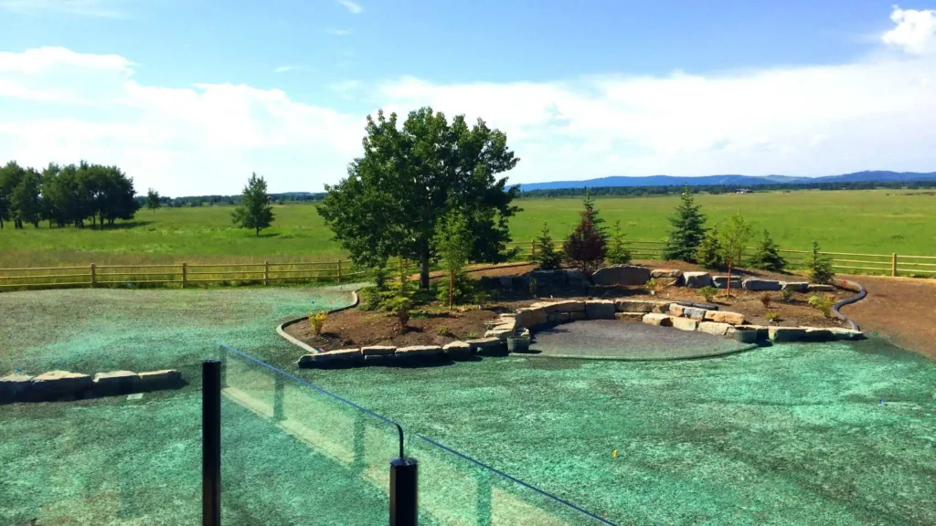 A view of an outdoor pool with trees in the background.